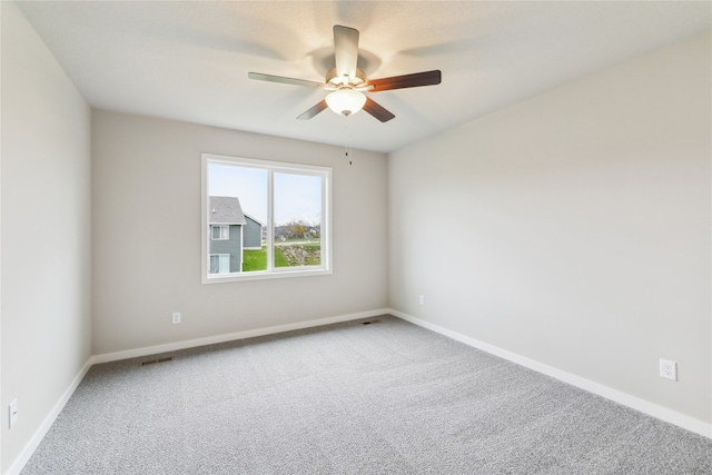 spare room with carpet and ceiling fan