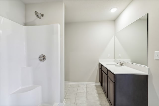 bathroom featuring a shower and vanity