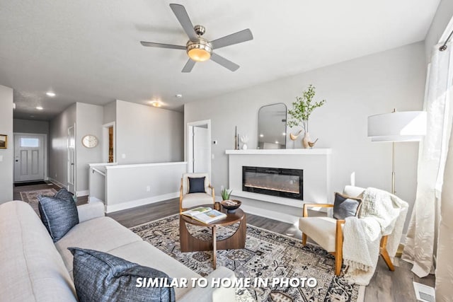 living room with hardwood / wood-style flooring and ceiling fan