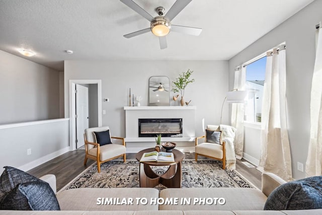 living room featuring hardwood / wood-style flooring and ceiling fan