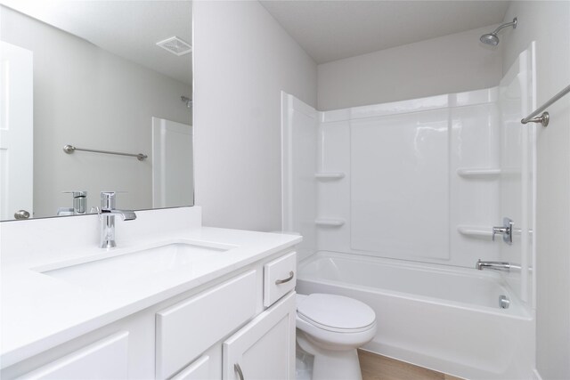 full bathroom with toilet, visible vents, shower / washtub combination, and vanity