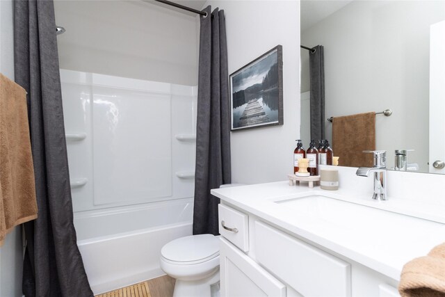 bathroom with toilet, shower / tub combo with curtain, and vanity