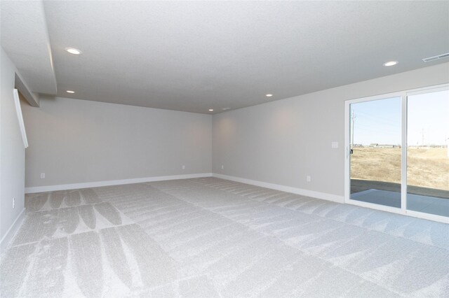 carpeted empty room with recessed lighting, visible vents, a textured ceiling, and baseboards