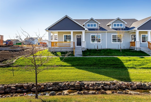 view of front of house featuring covered porch and a front lawn