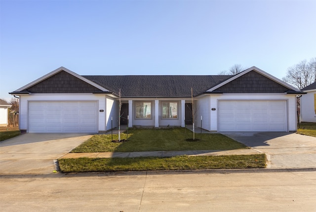 ranch-style house featuring a front yard and a garage