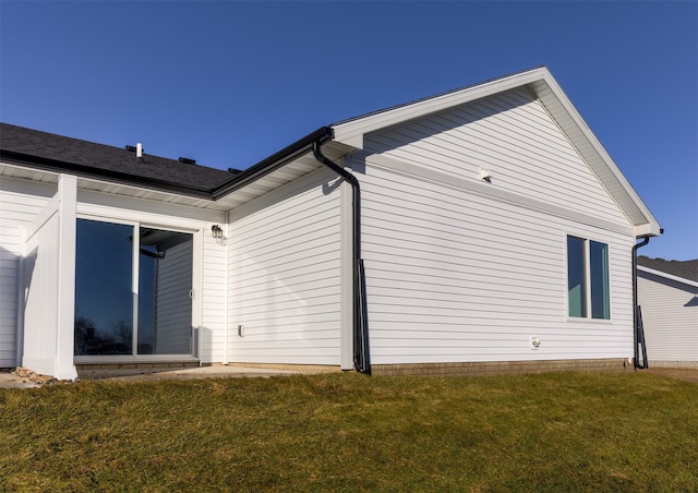 view of side of home featuring a lawn