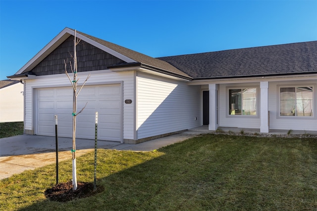 view of front of house with a garage and a front lawn