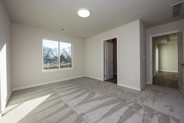 empty room with light colored carpet