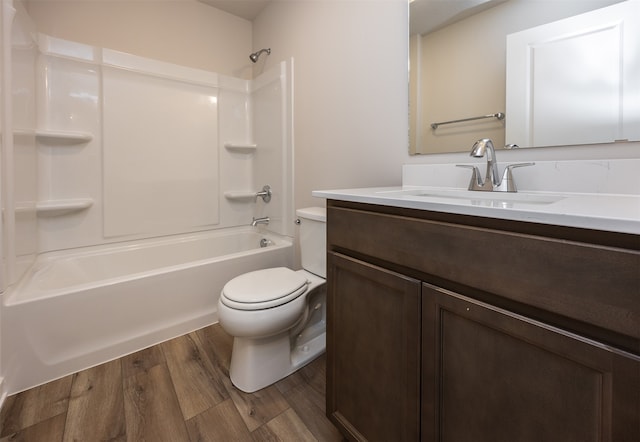 full bathroom with hardwood / wood-style flooring, vanity, toilet, and washtub / shower combination