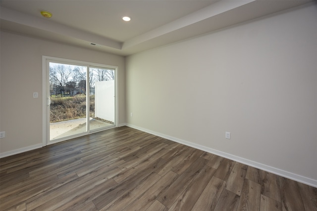 spare room with dark hardwood / wood-style flooring