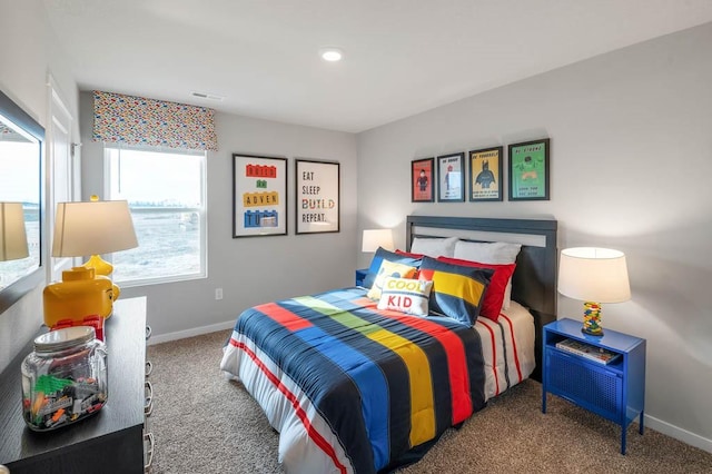 carpeted bedroom featuring visible vents and baseboards