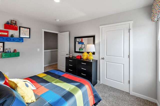 bedroom featuring carpet flooring and baseboards