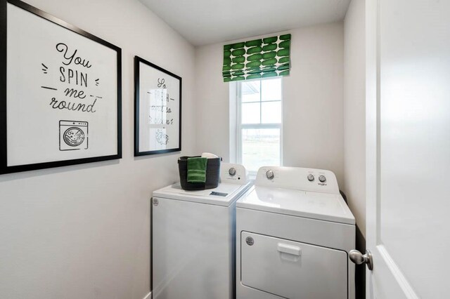 washroom with laundry area and washer and dryer