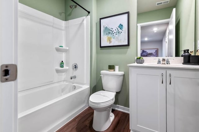 full bathroom with toilet, bathing tub / shower combination, hardwood / wood-style floors, and vanity