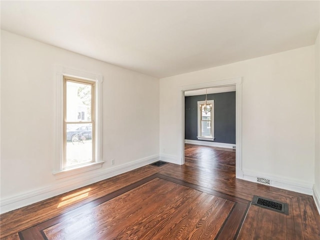 spare room featuring dark wood-type flooring