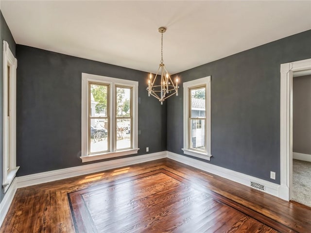 unfurnished dining area with a chandelier