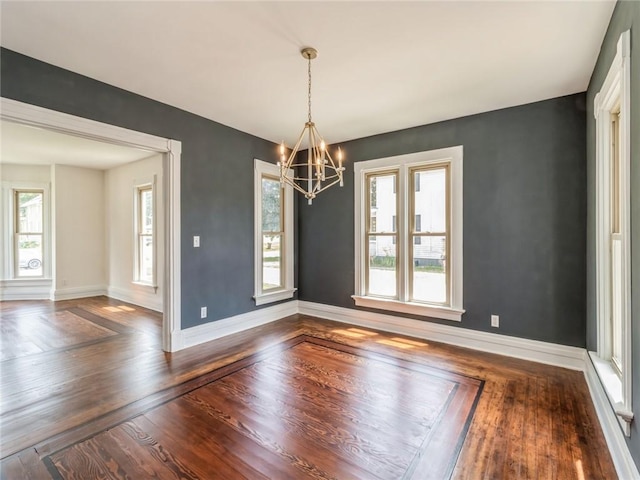 unfurnished dining area with an inviting chandelier