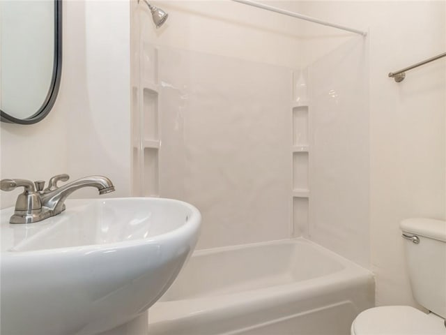 full bathroom with sink, washtub / shower combination, and toilet