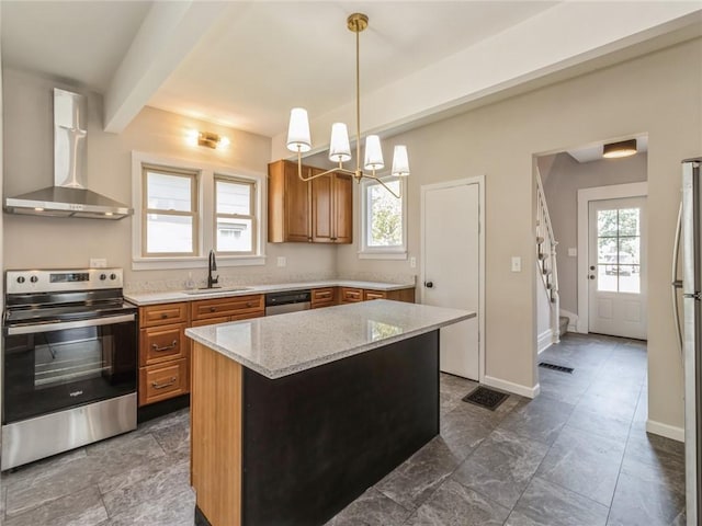 kitchen featuring a center island, wall chimney range hood, sink, light stone countertops, and stainless steel appliances