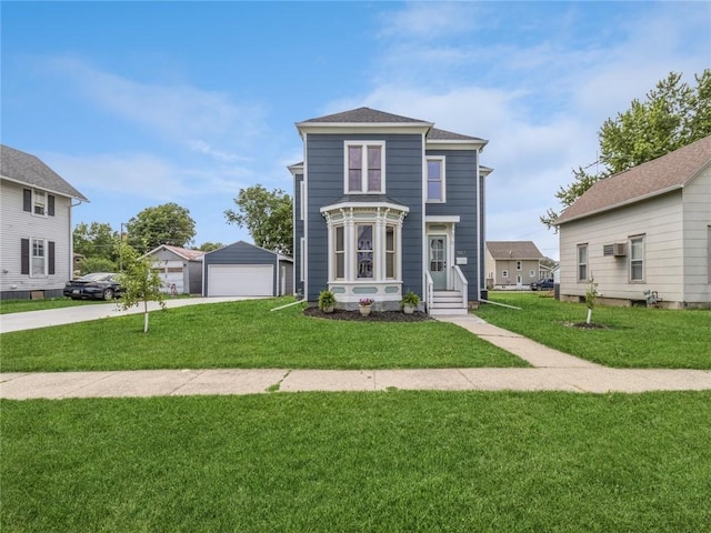 view of front facade with a front yard, a garage, and an outdoor structure