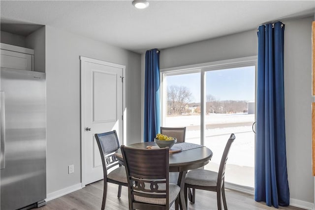 dining area with light hardwood / wood-style floors