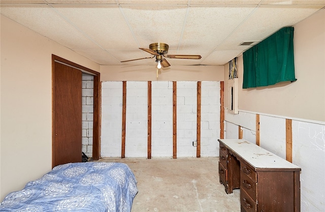 bedroom with ceiling fan and a drop ceiling