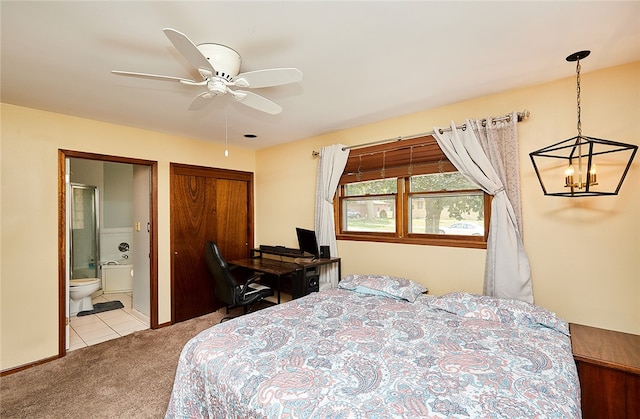 carpeted bedroom with ceiling fan with notable chandelier and connected bathroom