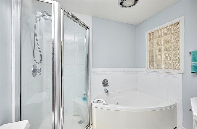 bathroom with separate shower and tub