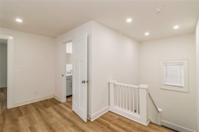 corridor with light hardwood / wood-style floors