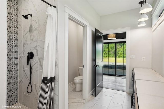 bathroom featuring tile floors, vanity, toilet, and curtained shower