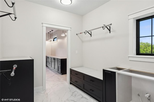 walk in closet featuring light tile floors