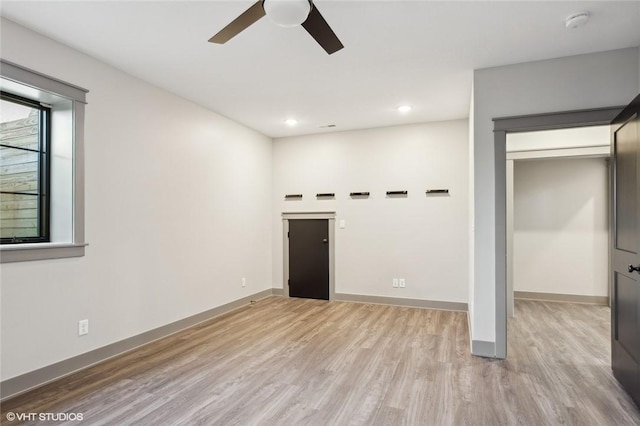 unfurnished living room with ceiling fan and light hardwood / wood-style floors