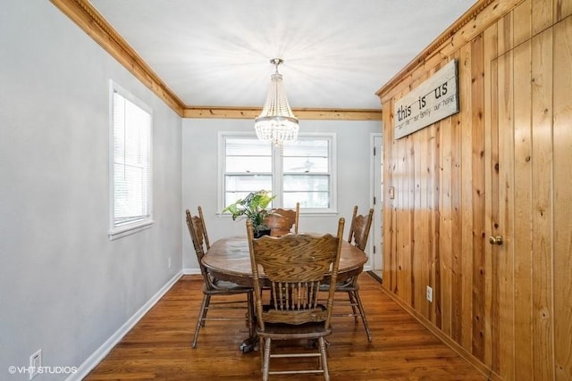 dining room with ornamental molding, plenty of natural light, a notable chandelier, and dark hardwood / wood-style flooring