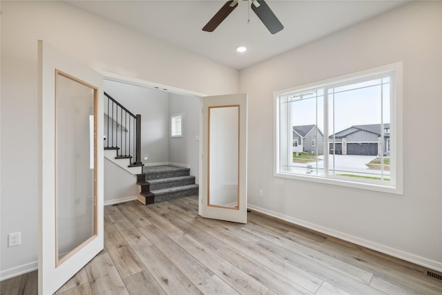 interior space with light hardwood / wood-style floors, french doors, and ceiling fan