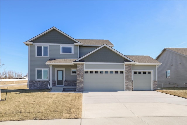 craftsman inspired home featuring a garage and a front lawn