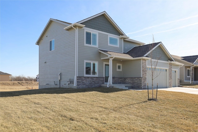 craftsman-style home with a garage and a front lawn