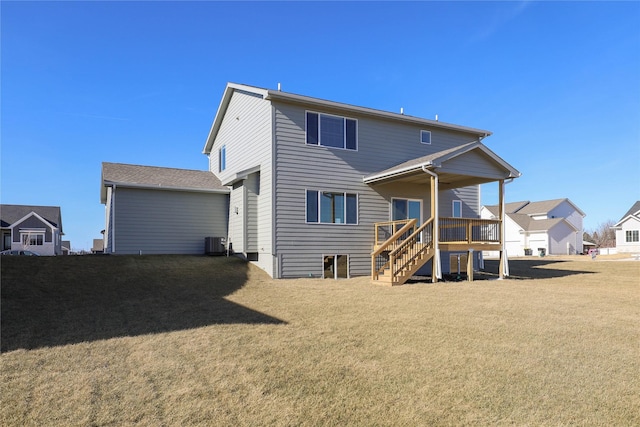 back of house featuring a yard and central AC unit