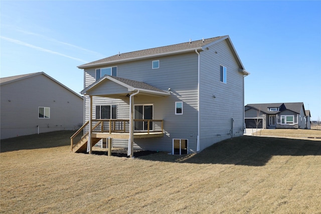 back of property with a deck and a lawn