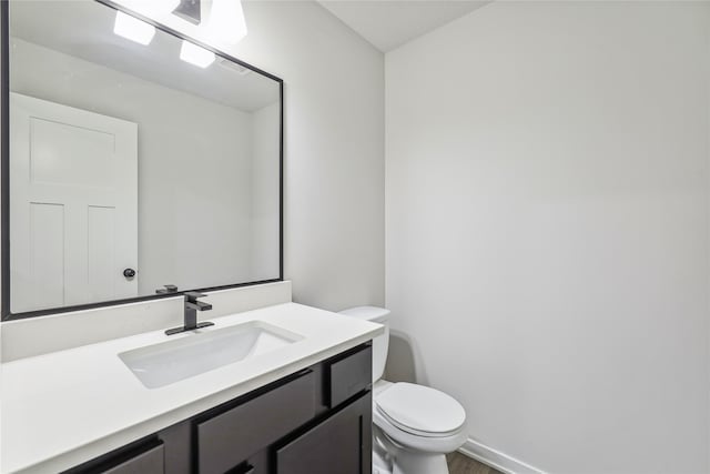 bathroom with toilet and vanity