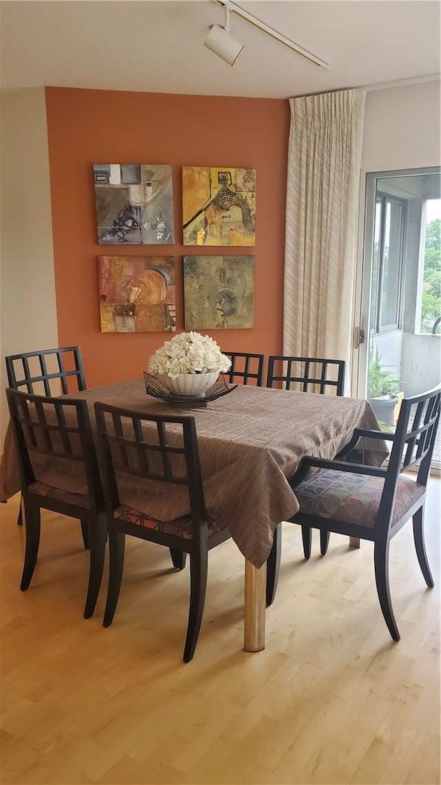 dining space with hardwood / wood-style flooring