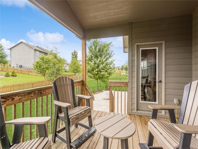 wooden deck featuring a lawn