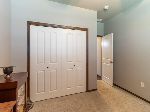 carpeted bedroom with a closet