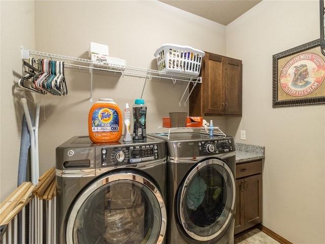 laundry area featuring cabinets and washing machine and dryer