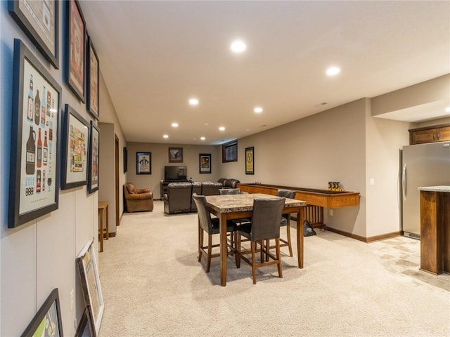 dining space featuring light carpet