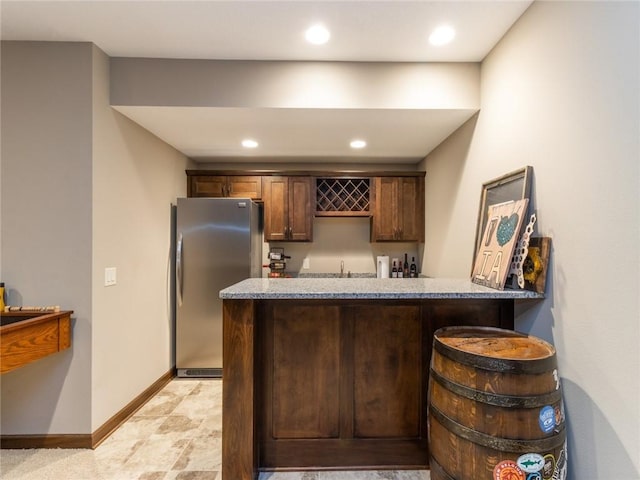 bar with sink and stainless steel fridge