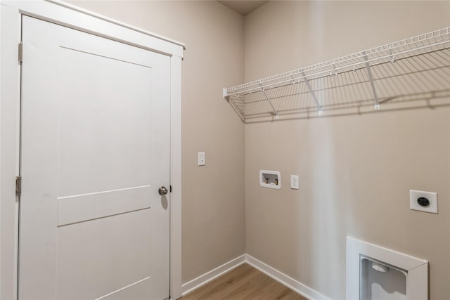 clothes washing area with hookup for a washing machine, wood-type flooring, and electric dryer hookup