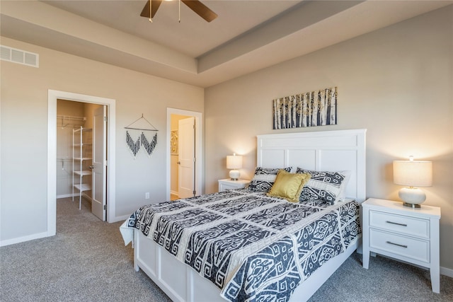 carpeted bedroom featuring ensuite bath, a closet, and ceiling fan