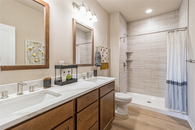 bathroom with a shower with shower curtain, vanity, toilet, and hardwood / wood-style floors