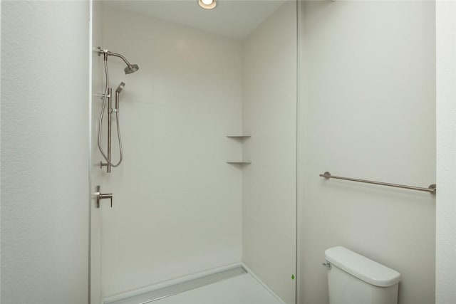 bathroom with toilet and walk in shower