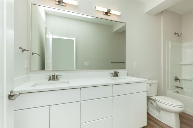 full bathroom featuring wood-type flooring, vanity, toilet, and tub / shower combination